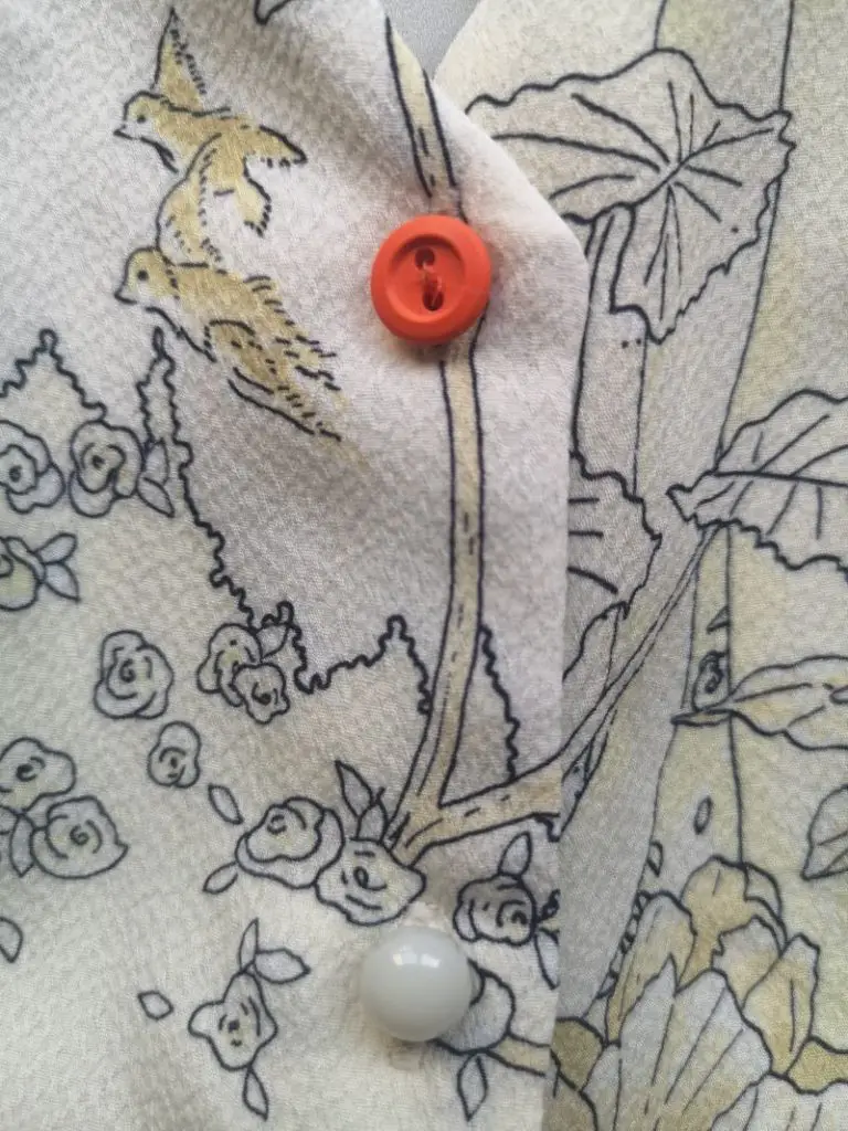 mending clothes accent button on dress