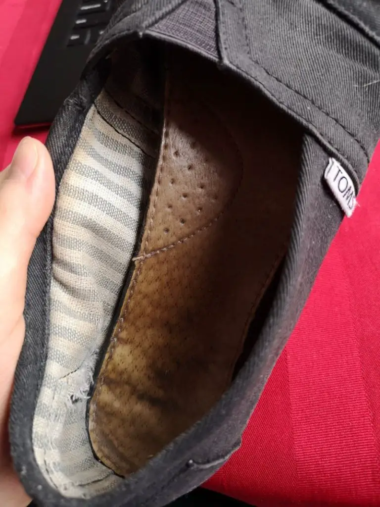 mending clothes putting glue back on shoe insole