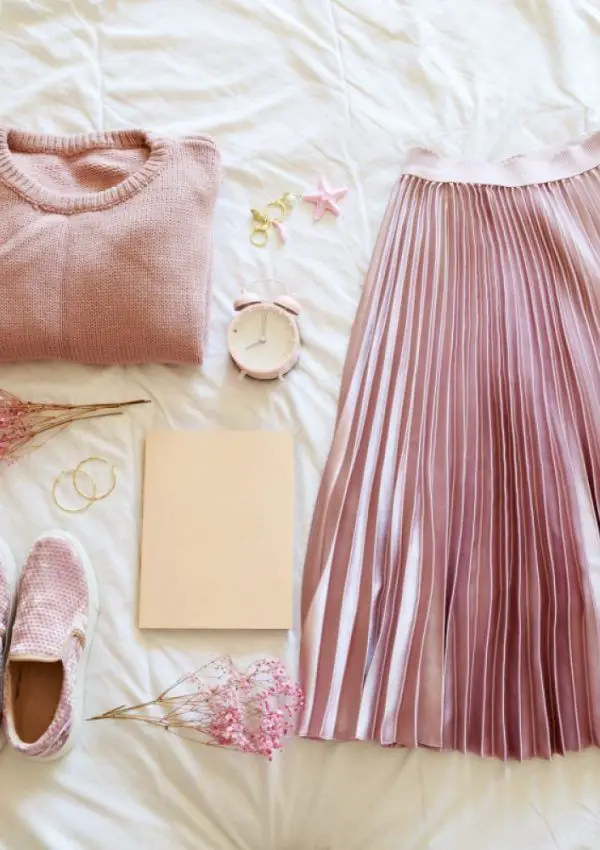 flat lay of a colorful capsule wardrobe outfit in shades of light pink