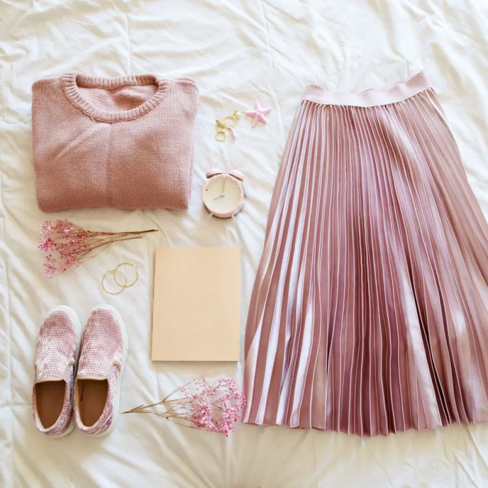 flat lay of a colorful capsule wardrobe outfit in shades of light pink