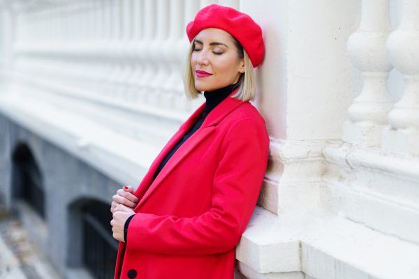 red hat and sapphire blazer showing a jewel tone capsule wardrobe